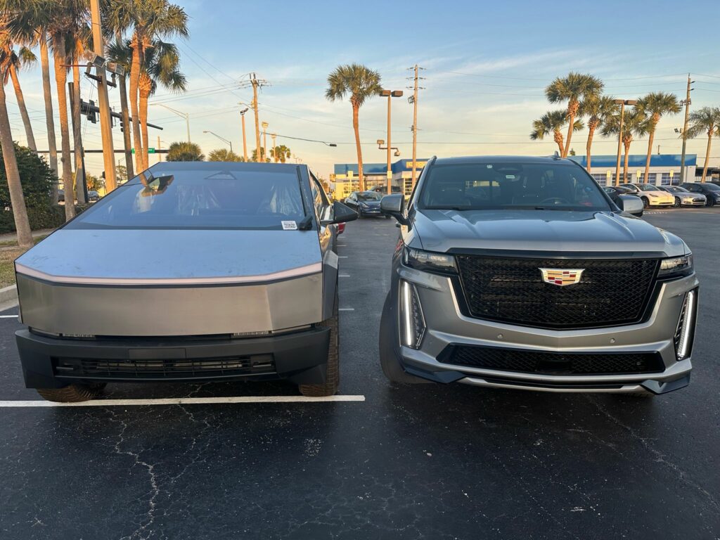 Two modern SUVs parked side by side, one with a futuristic design and the other styled as a traditional luxury limousine, ready for airport transfers in Orlando.
